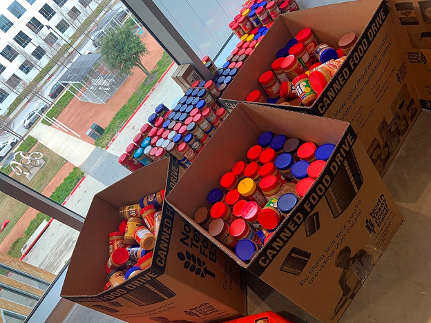 Jars of peanut butter in boxes labelled "Canned Food Drive"